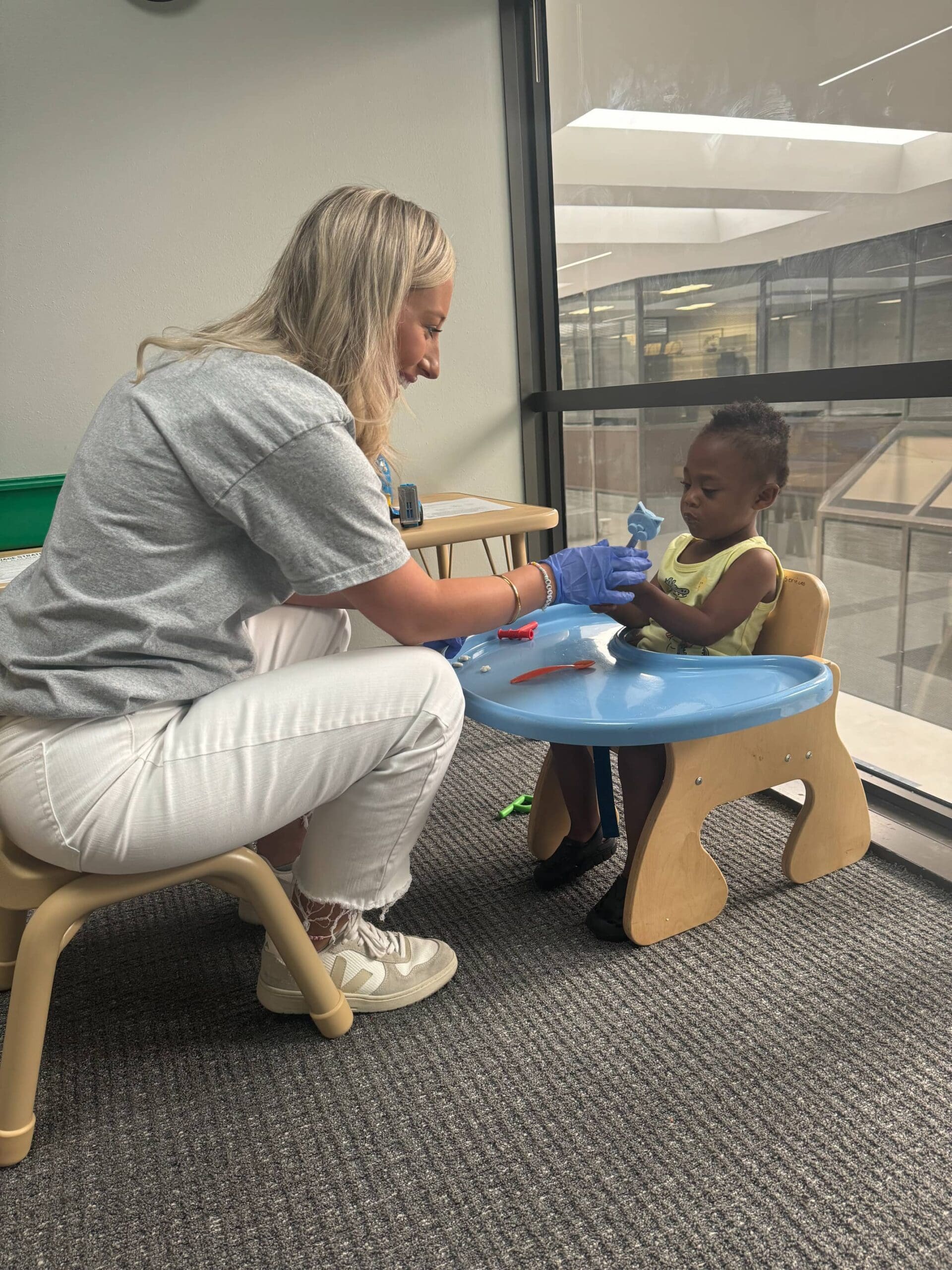 An infant boy with a feeding disorder works on feeding therapy at Bliss Speech and Hearing Services.