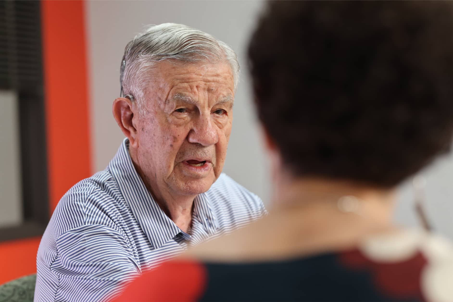 An elderly man with Cochlear Implant works on Aural Rehabilitation at Bliss Speech and Hearing Services.