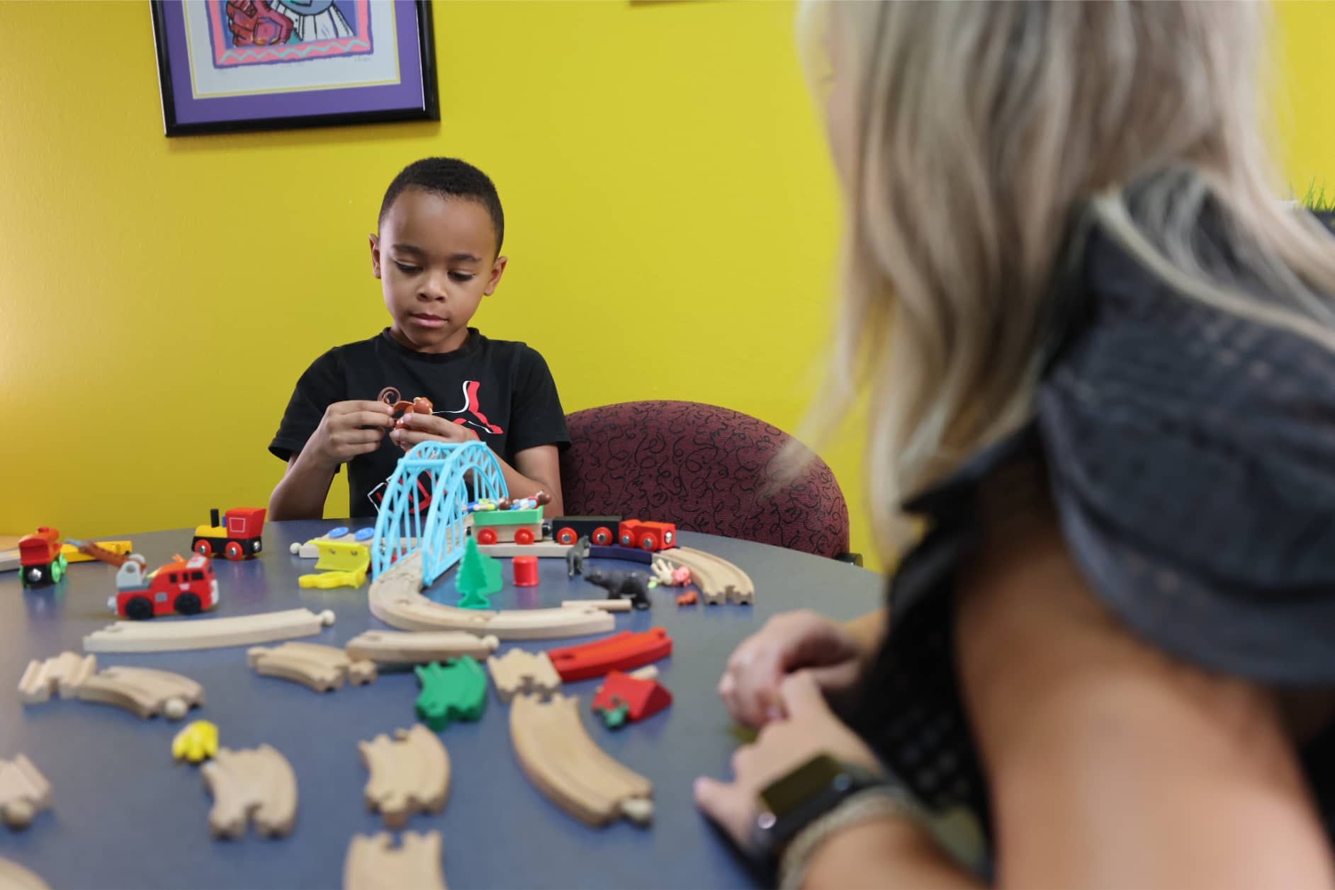 A young boy with a speech and language disorder working on articulation skills at Bliss Speech and Hearing Services.