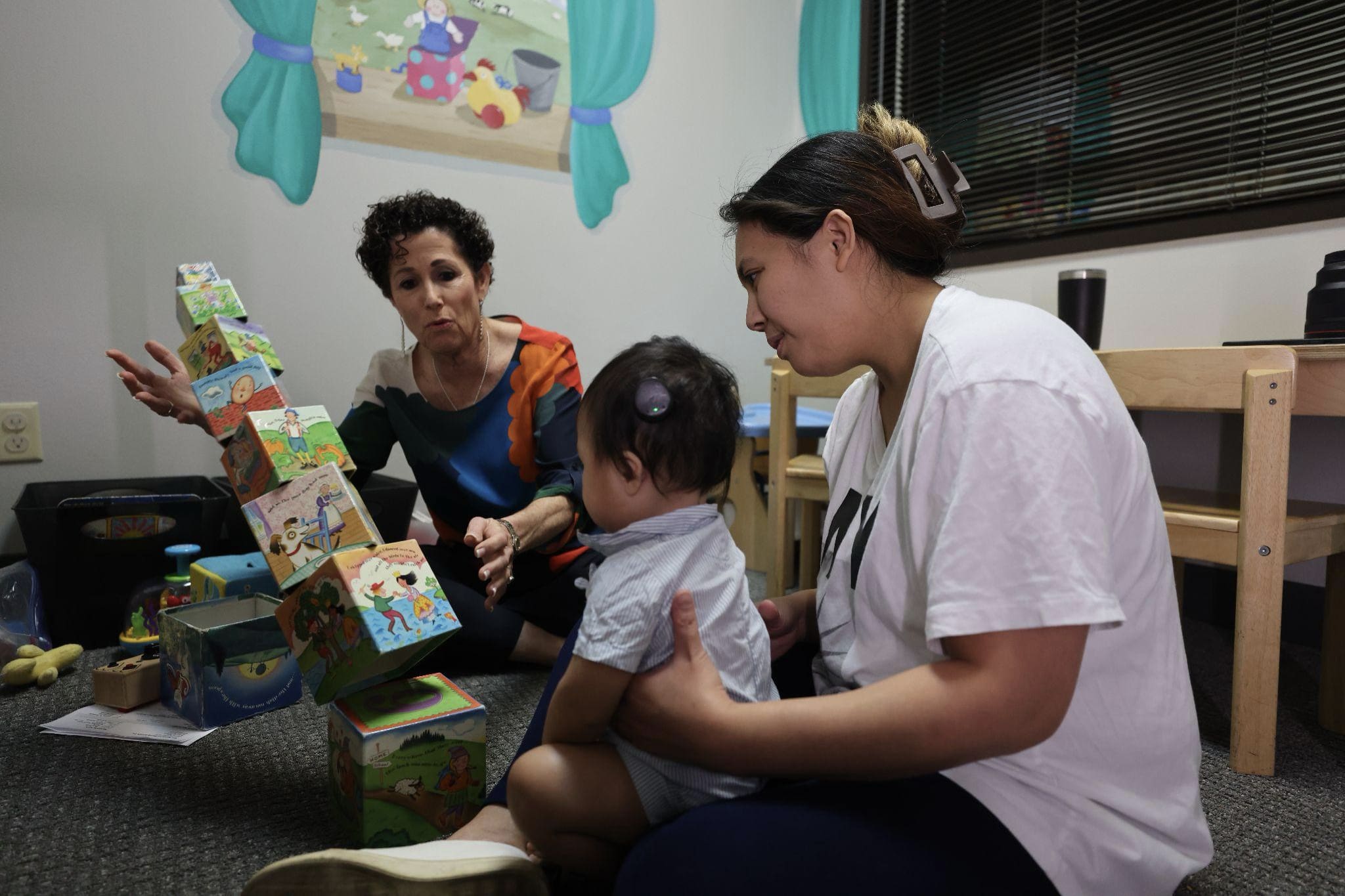 An infant with cochlear implants working with an Auditory-Verbal Therapist at Bliss Speech and Hearing Services.