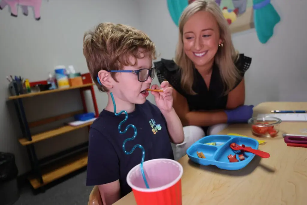 A young boy with a feeding and swallowing disorder working on feeding therapy at Bliss Speech and Hearing Services