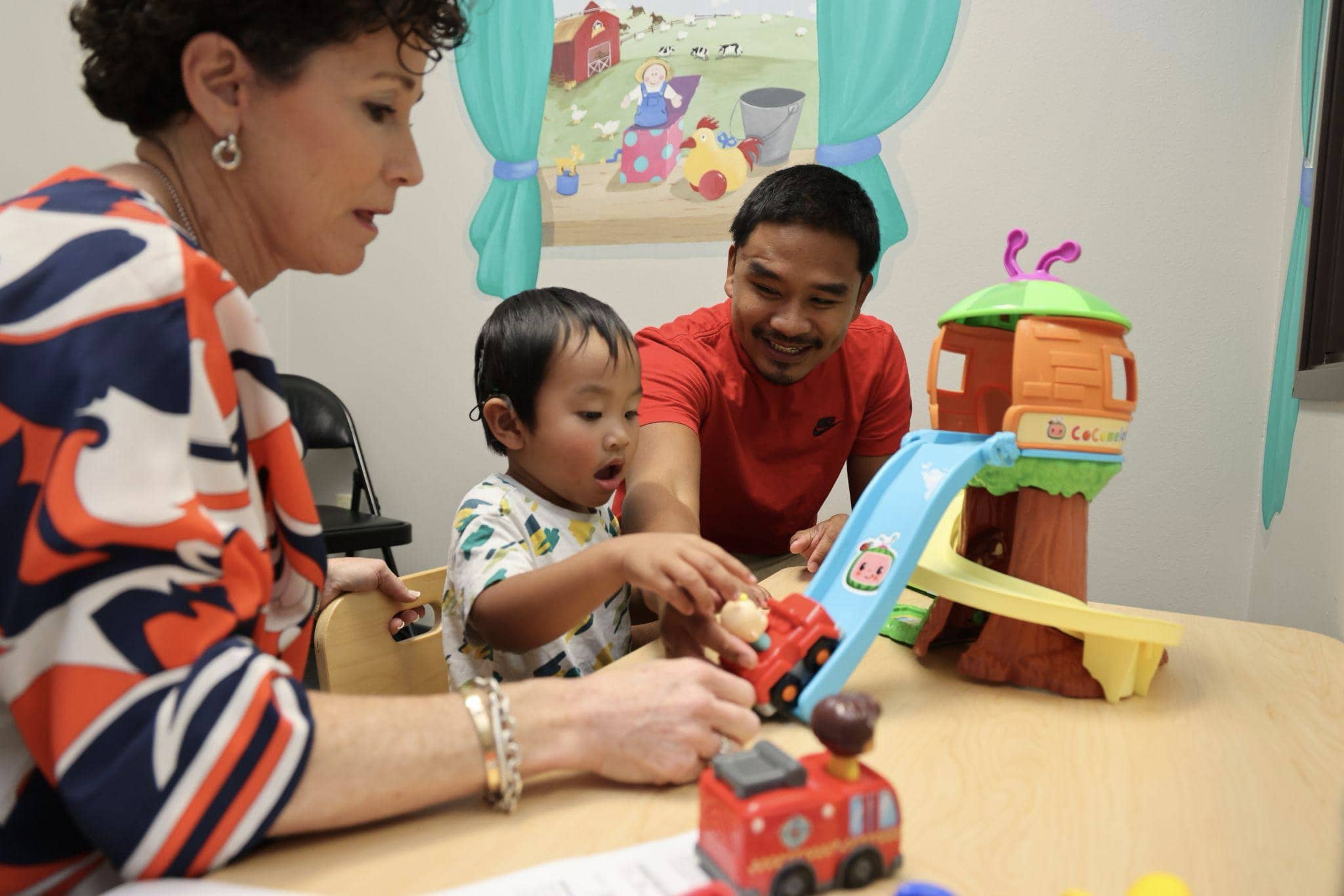 A young child with complete hearing loss working on listening and spoken language at Bliss Speech and Hearing Services.