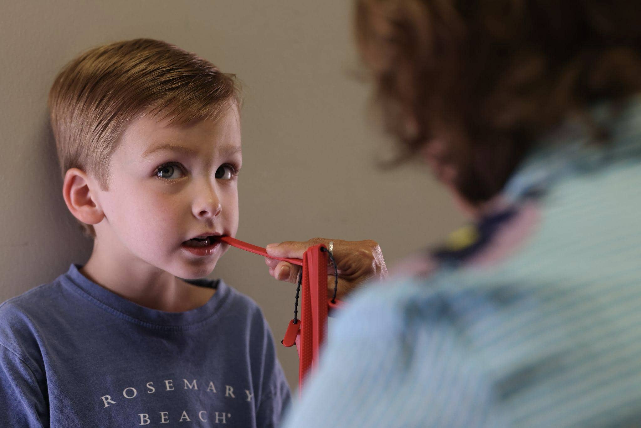 A young boy with an oral motor deficit works on oral motor function with Talk Tools at Bliss Speech and Hearing Services.