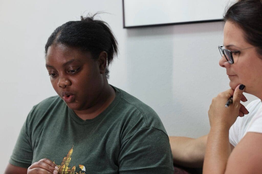 An adult woman working on voice disorders through an individualized therapy plan at Bliss Speech and Hearing Services.