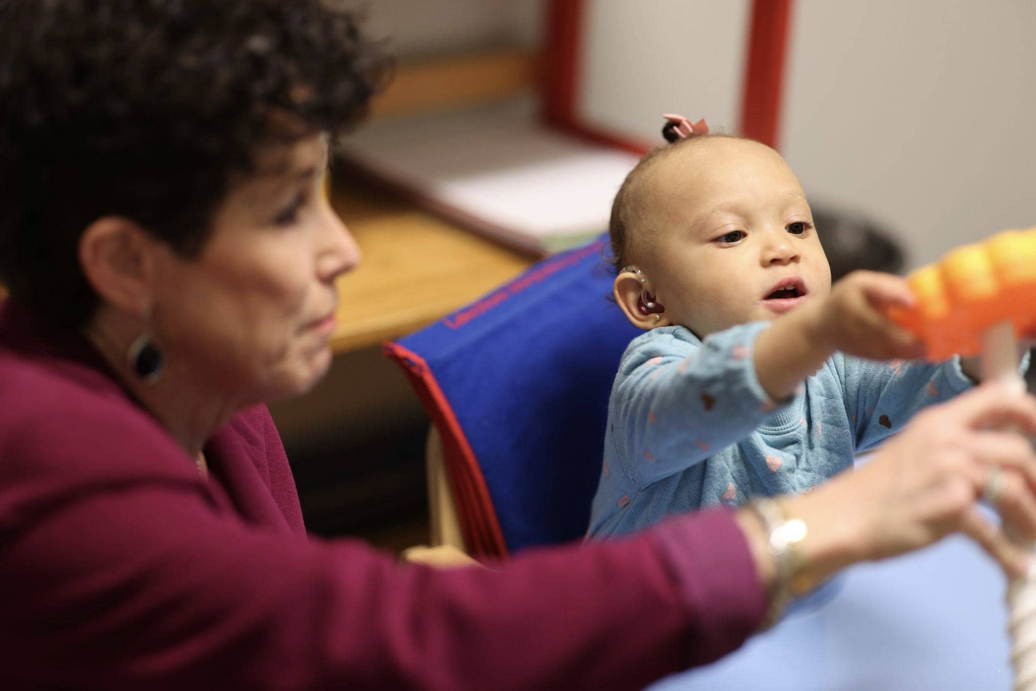 An infant with cochlear implants improving listening and spoken language skills at Bliss Speech and Hearing Services.