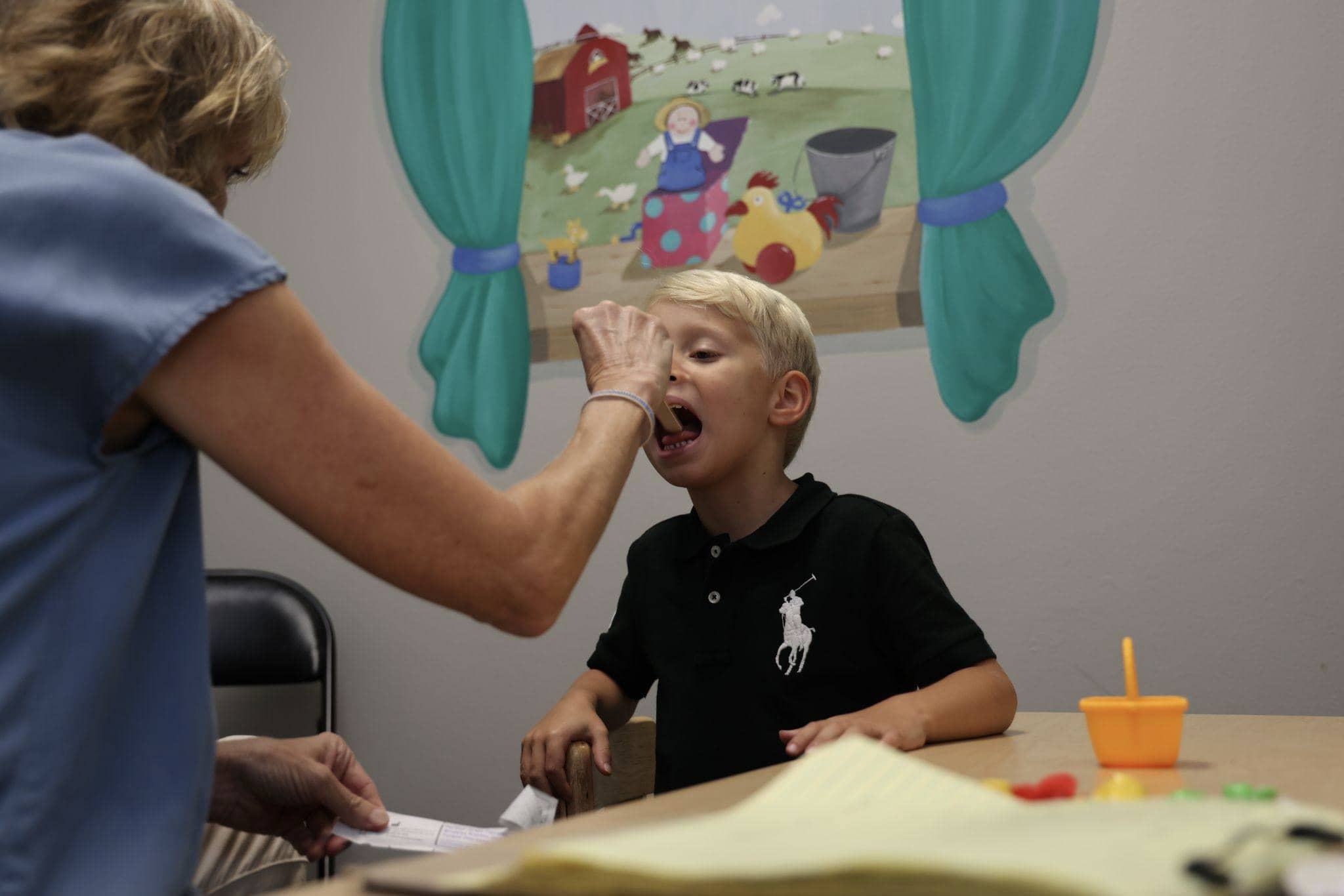 A boy with an oral motor deficit works on his oral motor function with Talk Tools at Bliss Speech and Hearing Services.