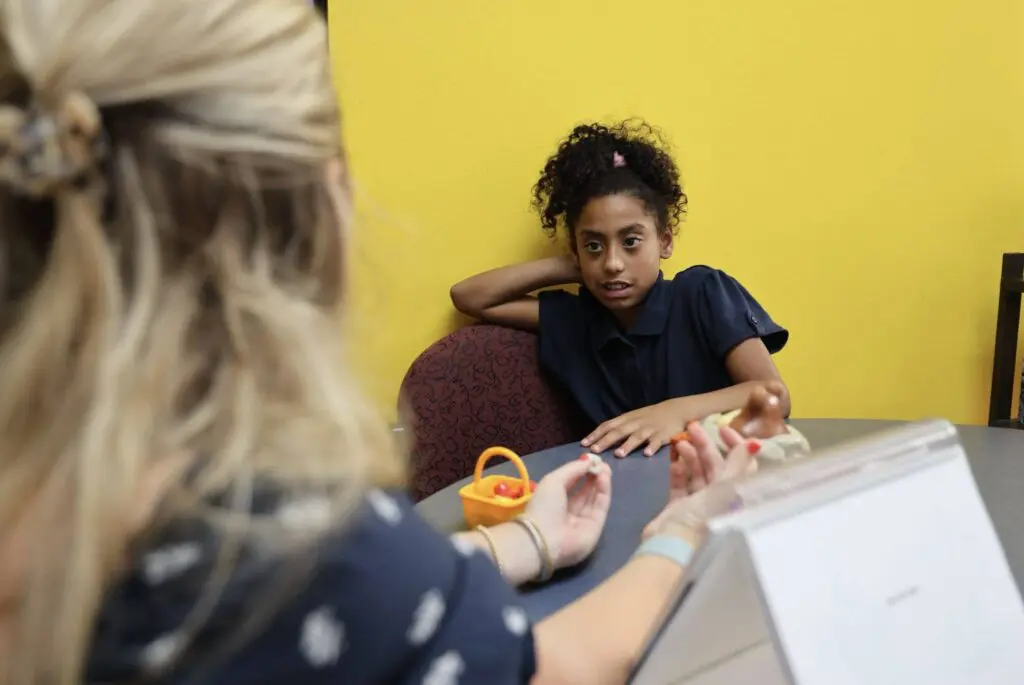 A young girl working on improving her speech with the speech therapy services at Bliss Speech and Hearing Services.